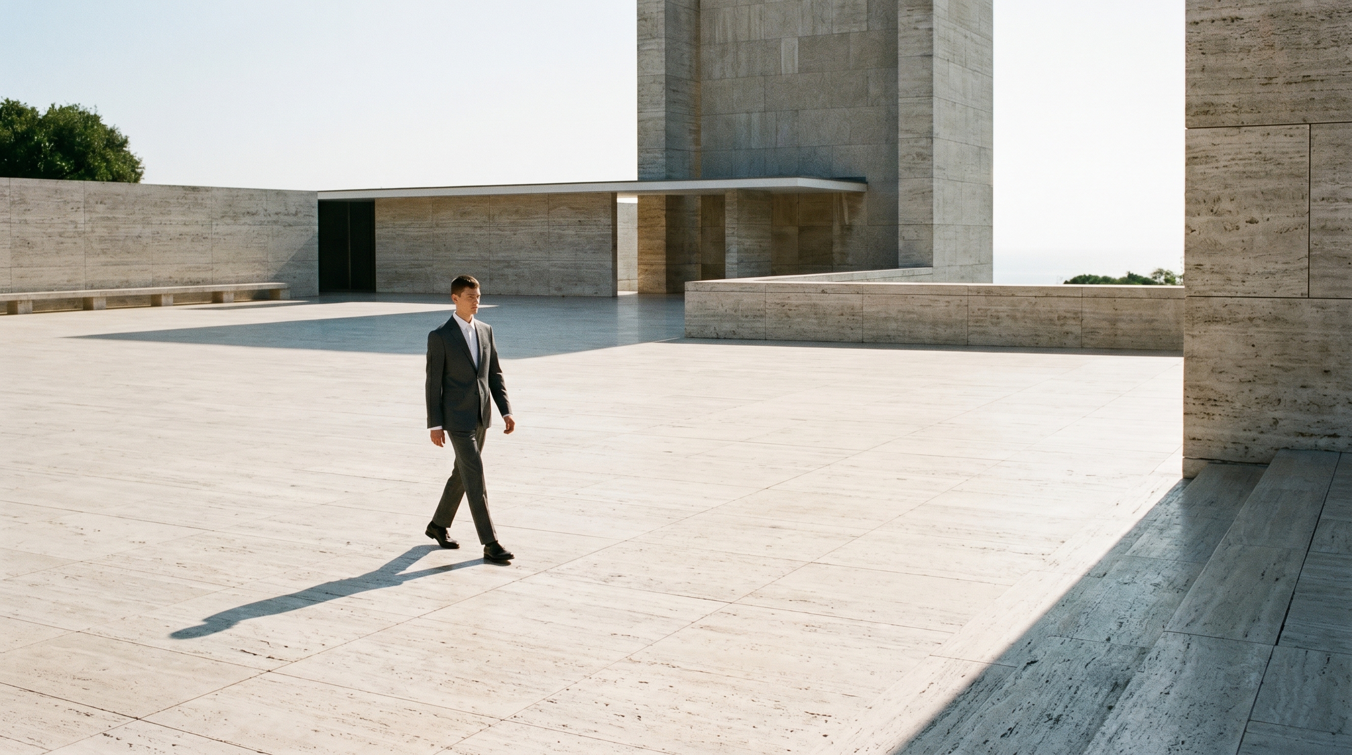 Beige summer suit against warm plaster